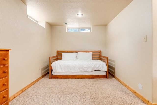 unfurnished bedroom with carpet and a textured ceiling