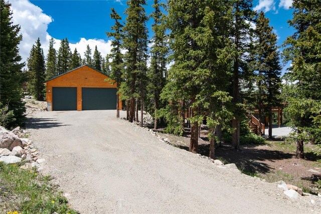 view of front of property with a garage and an outdoor structure