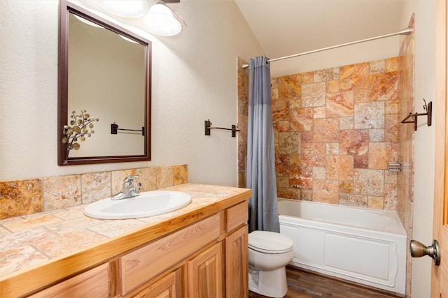 full bathroom featuring vanity, toilet, shower / bathtub combination with curtain, and lofted ceiling