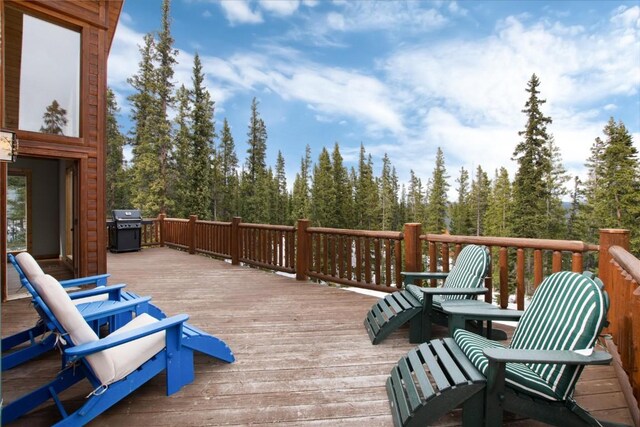 wooden deck featuring a grill