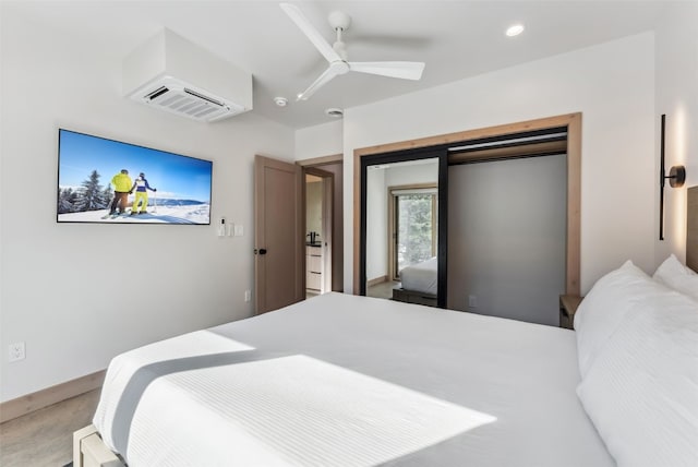 bedroom with a wall mounted air conditioner, recessed lighting, and a ceiling fan