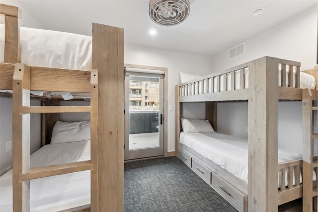 bedroom featuring dark colored carpet and visible vents