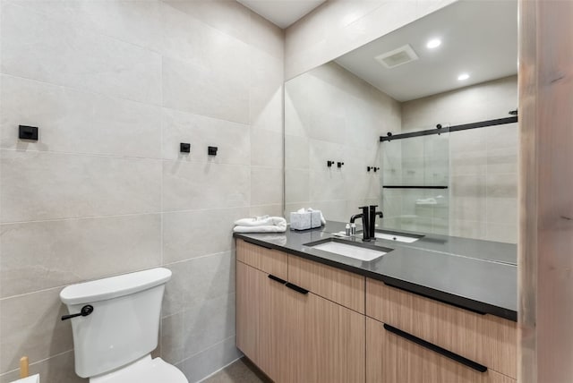 full bath featuring visible vents, toilet, a stall shower, tile walls, and vanity