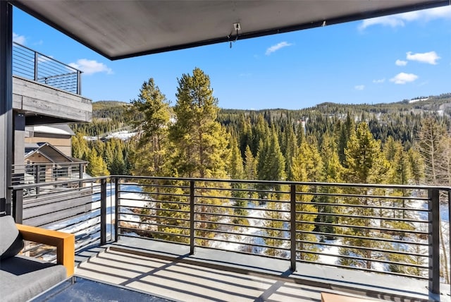 balcony featuring a view of trees