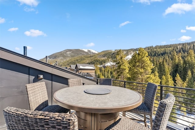 balcony featuring a mountain view and a forest view