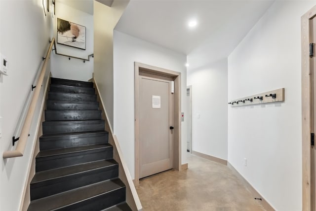 stairs with recessed lighting, baseboards, and concrete flooring