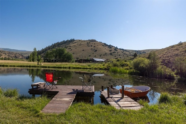 dock area featuring a water and mountain view