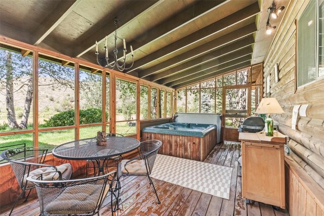 sunroom featuring vaulted ceiling with beams