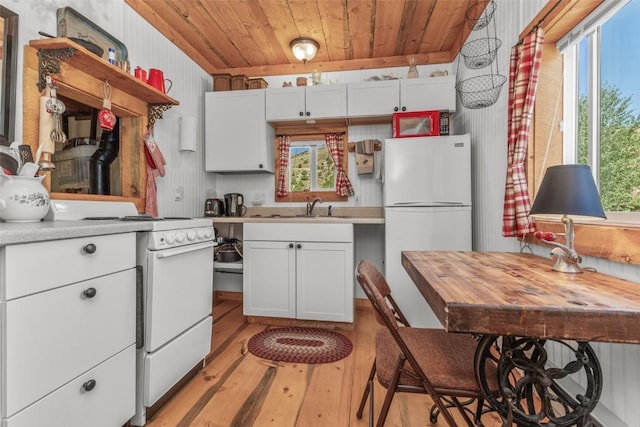 kitchen with white appliances, light hardwood / wood-style flooring, white cabinetry, and wood ceiling