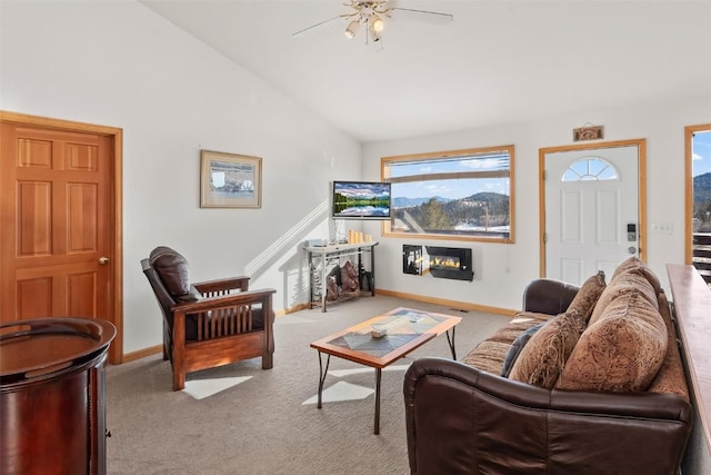 carpeted living room with ceiling fan and high vaulted ceiling