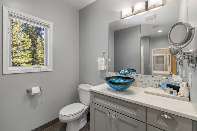 bathroom with tile patterned flooring, vanity, and toilet