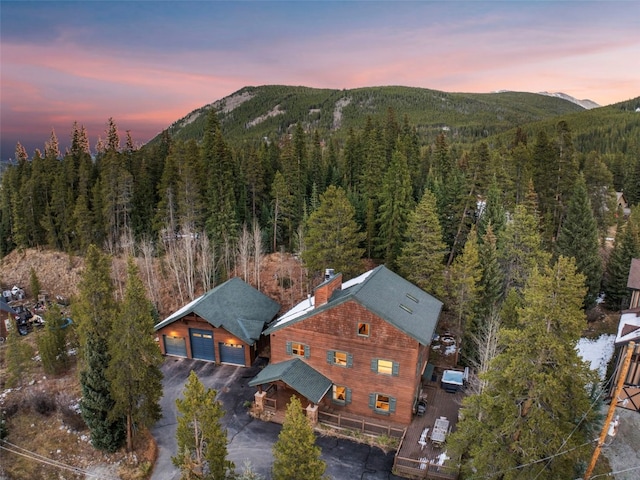 aerial view at dusk featuring a mountain view