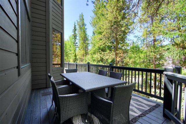 wooden terrace featuring outdoor dining area