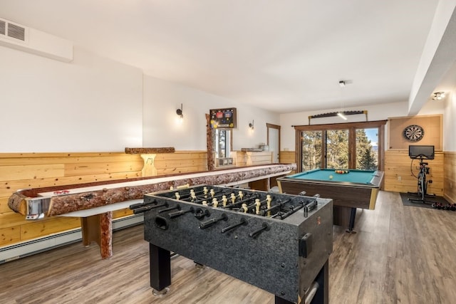 recreation room with wooden walls, visible vents, wood finished floors, and wainscoting