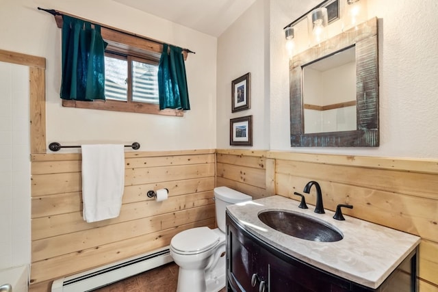 bathroom with wooden walls, toilet, a wainscoted wall, a baseboard radiator, and vanity