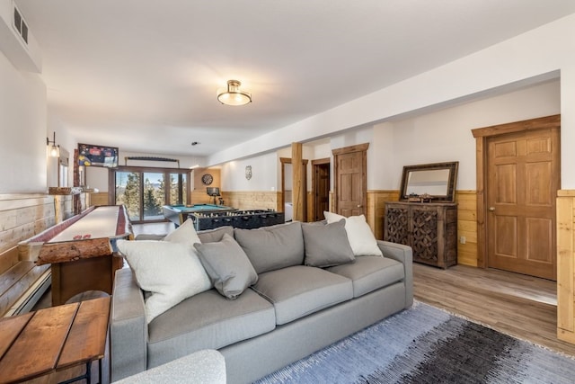 living room with billiards, wooden walls, visible vents, a wainscoted wall, and wood finished floors