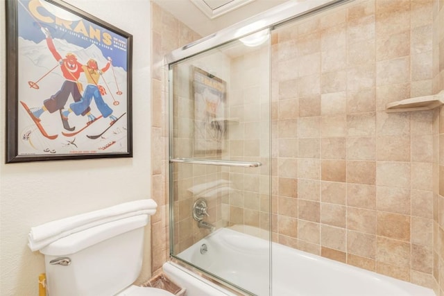 bathroom featuring toilet and combined bath / shower with glass door