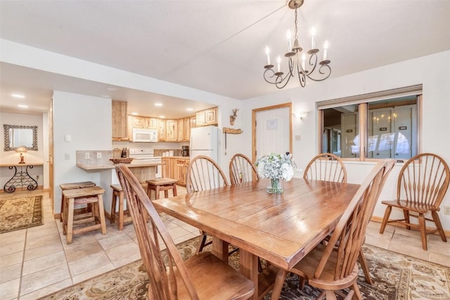 dining room featuring a chandelier and light tile patterned floors