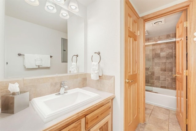 bathroom with tile patterned flooring, vanity, enclosed tub / shower combo, and electric panel