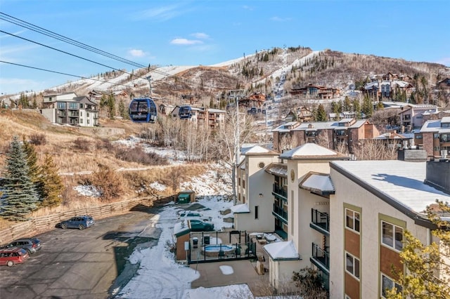 snowy aerial view featuring a mountain view