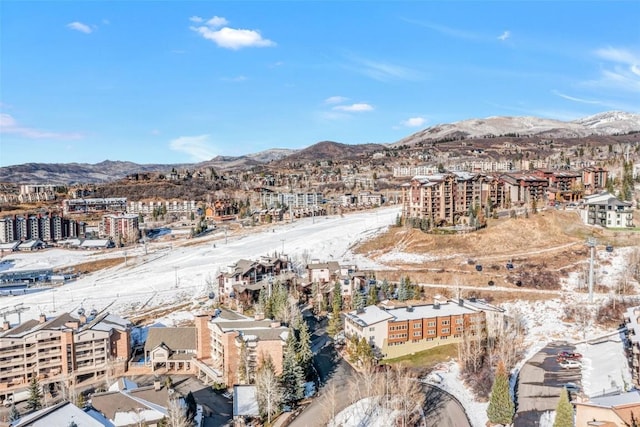 snowy aerial view with a mountain view