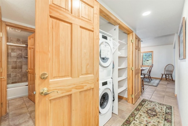 clothes washing area featuring stacked washer and dryer