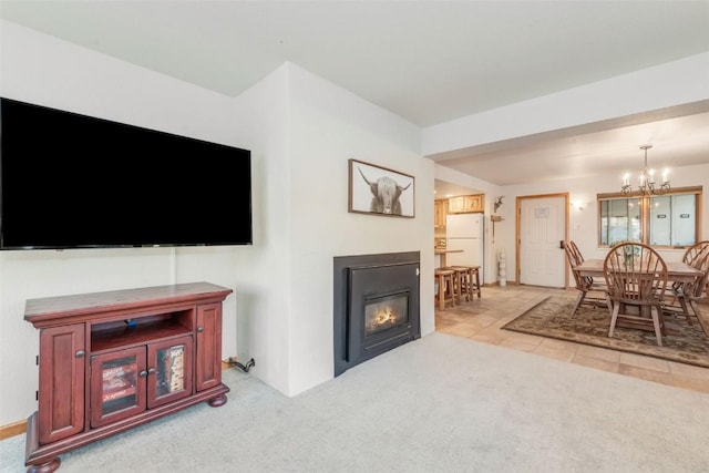 living room with light carpet and a notable chandelier