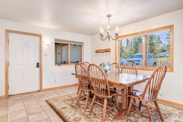 dining area with light tile patterned flooring and a chandelier