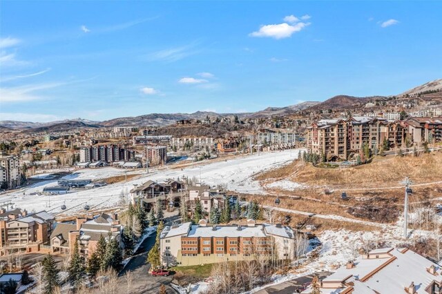 snowy aerial view with a mountain view