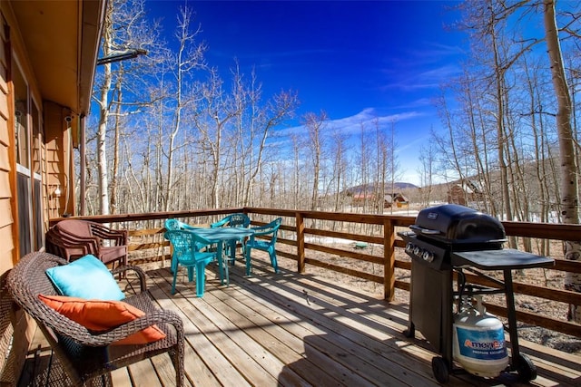 wooden terrace with a grill