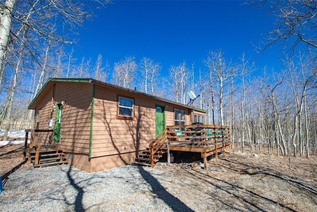 view of property exterior featuring a wooden deck