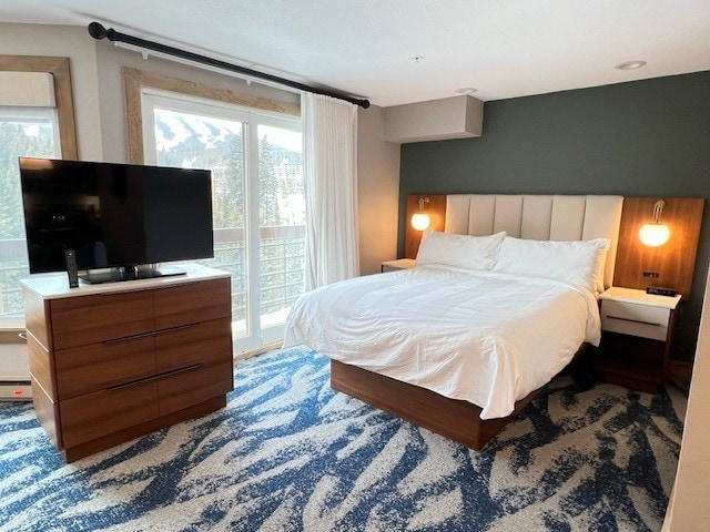 bedroom featuring a baseboard radiator and access to outside