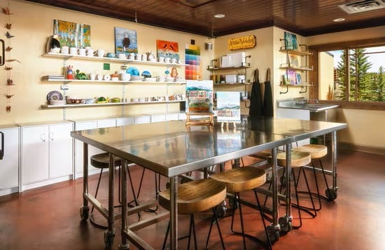 bar featuring wood ceiling, white cabinetry, and stainless steel counters