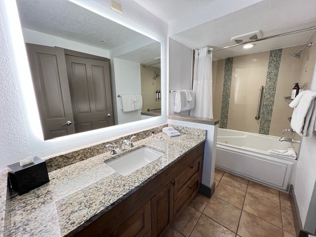 bathroom featuring tile patterned floors, vanity, a textured ceiling, and shower / bath combo