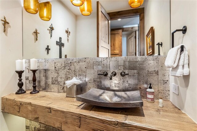 bathroom with decorative backsplash and sink