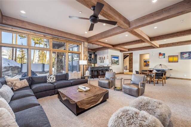 living room featuring beam ceiling, light carpet, and ceiling fan