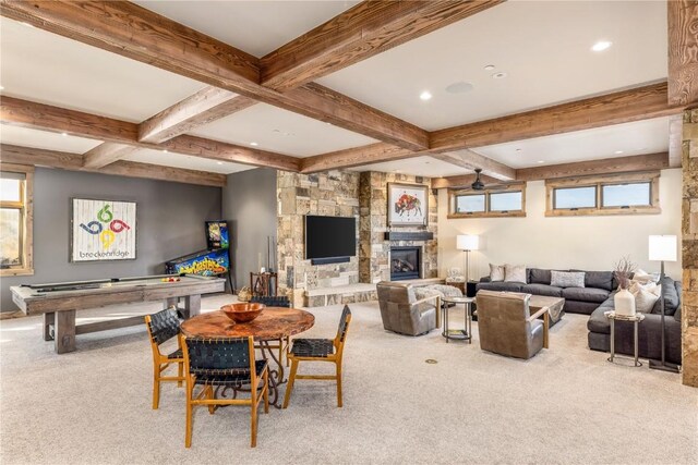 interior space with carpet, a fireplace, and beamed ceiling