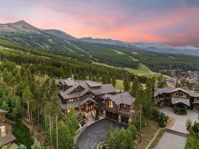 aerial view at dusk featuring a mountain view