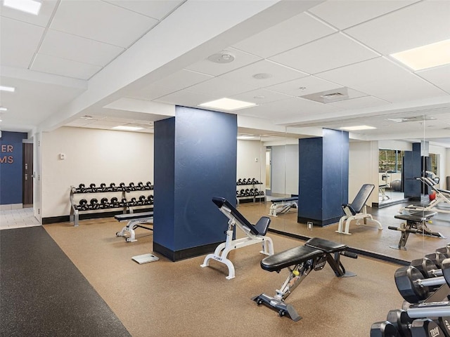 gym featuring a drop ceiling, visible vents, and baseboards