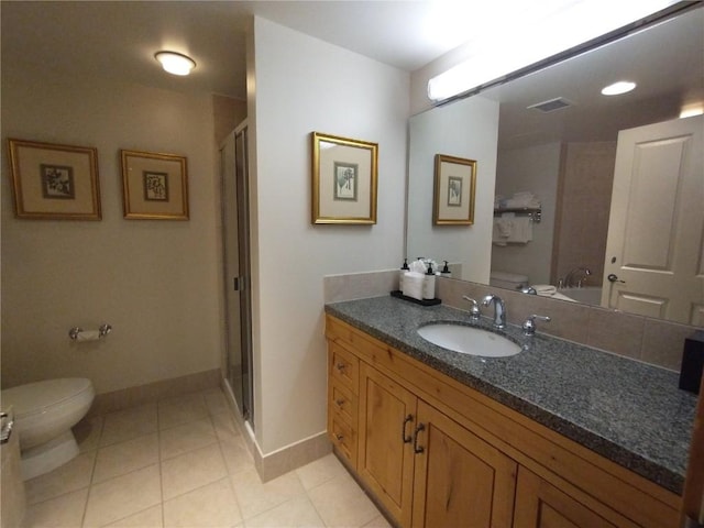 bathroom with tile patterned floors, visible vents, a stall shower, and toilet