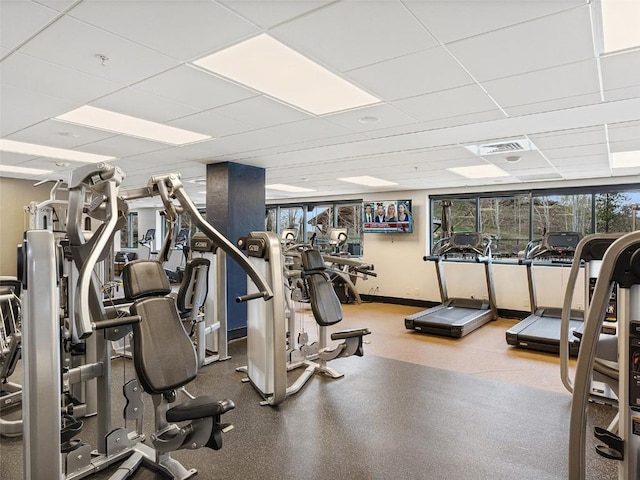 exercise room with a paneled ceiling