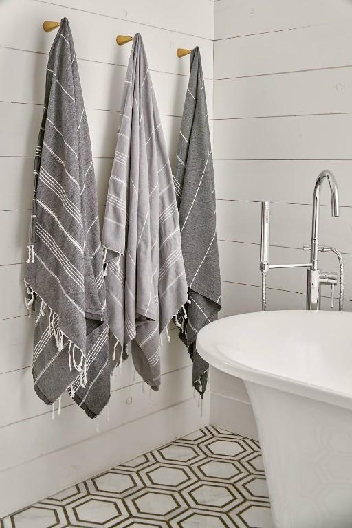 bathroom featuring wooden walls