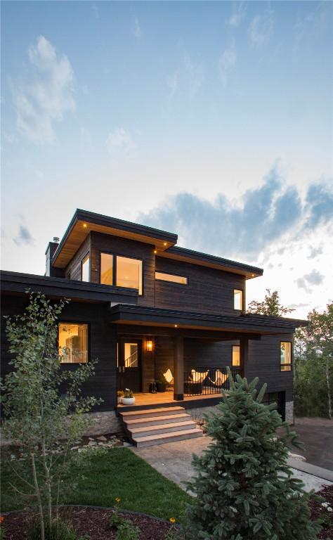 back of property with a porch and a chimney