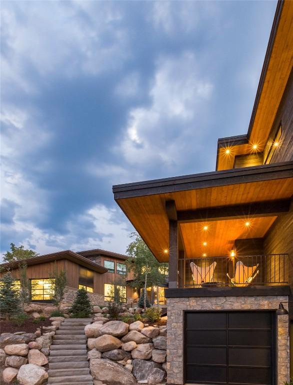 exterior space with stone siding and a balcony