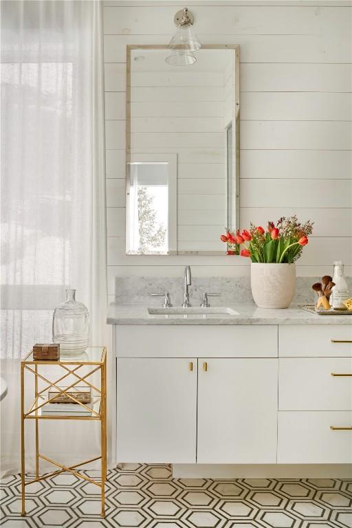 bathroom with wooden walls and vanity