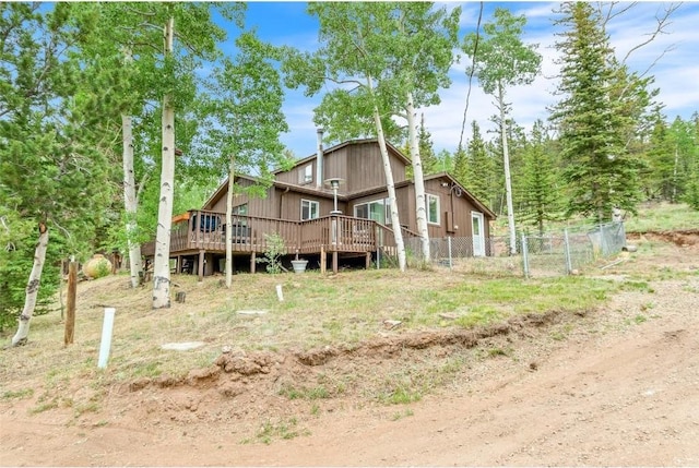 rear view of property featuring a wooden deck