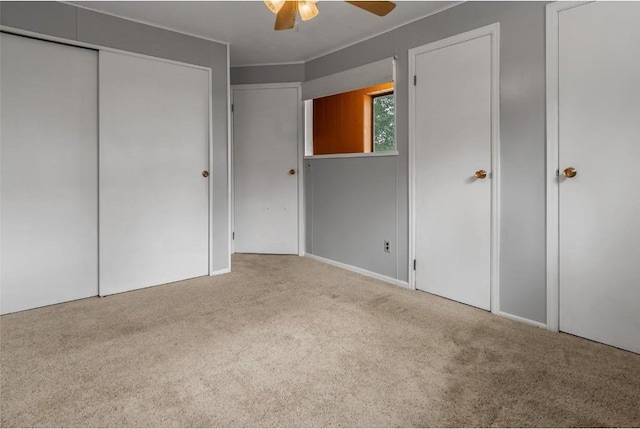 unfurnished bedroom featuring ceiling fan and light carpet