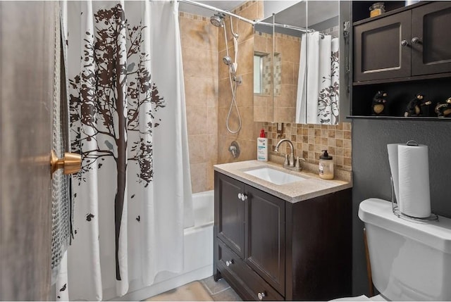 full bathroom featuring toilet, vanity, tasteful backsplash, and shower / bath combo with shower curtain