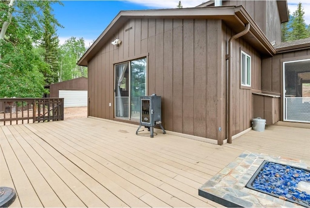 wooden deck with a garage and an outdoor structure