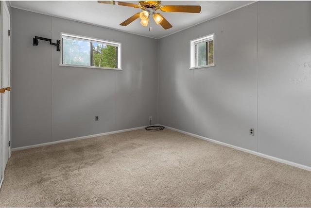 empty room with ceiling fan and carpet floors